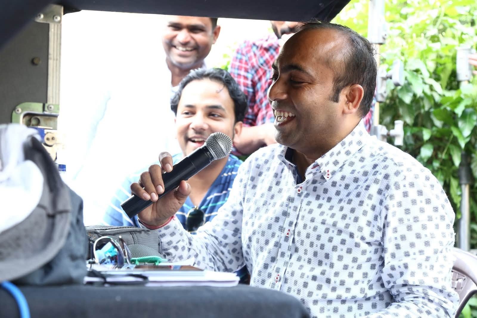 Sanjivkumar Rathod directing with a microphone